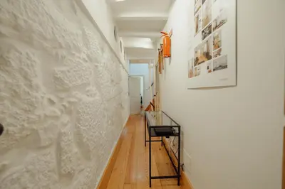 a hallway with a white wall and a glass table at Historical Duplex by Hosty in Porto