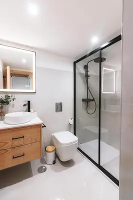 a bathroom with a shower and a toilet and a sink at Batalha Charming Loft in Porto