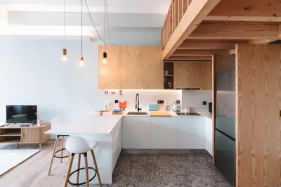 a kitchen with white cabinets and a white counter top at Batalha Charming Loft in Porto