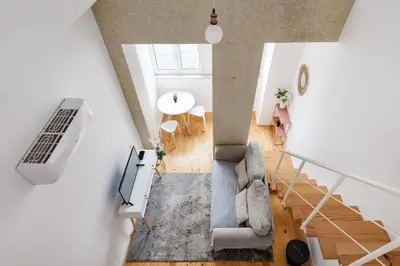 an overhead view of a living room with a couch at Mezzanine Studio in the City Center in Porto
