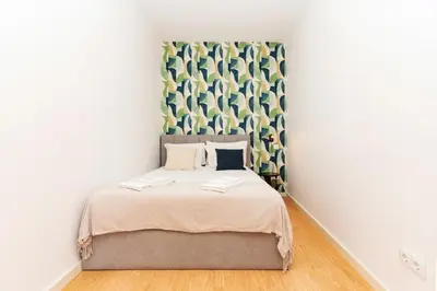 a bedroom with a large bed in a room at Charming Studio w/ Private Garden in St. Catarina in Porto