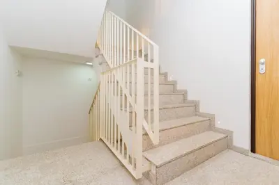 a staircase in a home with a white stair case at Charming Studio w/ Private Garden in St. Catarina in Porto