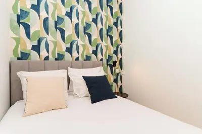 a bedroom with a bed with two pillows at Charming Studio w/ Private Garden in St. Catarina in Porto