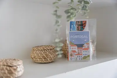 a book sitting on a shelf next to baskets at GuestReady - Welcoming place in Porto in Porto