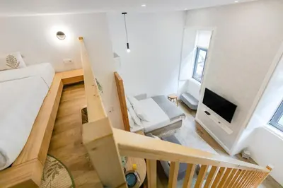 a room with white cabinets and a staircase at 252 Heroísmo Duplex Flat in Porto