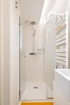 a white bathroom with a shower and a sink at St Ildefonso 03 in Porto