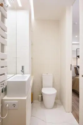 a white bathroom with a toilet and a sink at St Ildefonso 03 in Porto