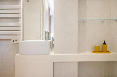 a white bathroom with a sink and a shower at St Ildefonso 03 in Porto