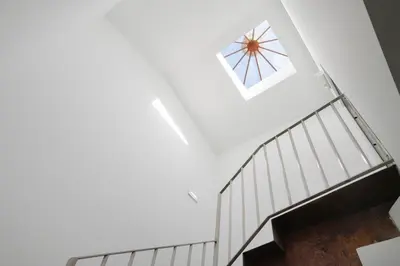 a spiral staircase with a skylight and a window at St Ildefonso 03 in Porto