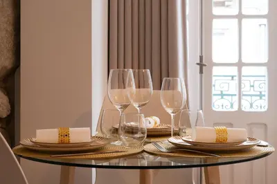 a table with wine glasses and plates on it at St Ildefonso 04 in Porto
