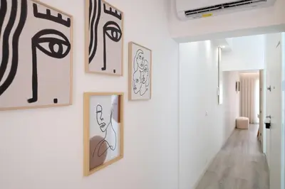 a hallway with framed art on the walls at St Ildefonso 06 in Porto