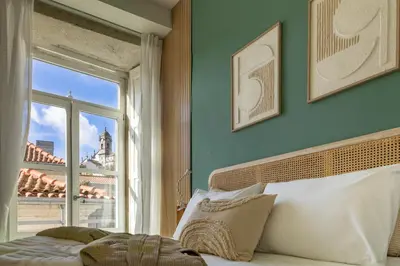 a bedroom with a bed and a window at Casa Flores - in Historical Center in Porto