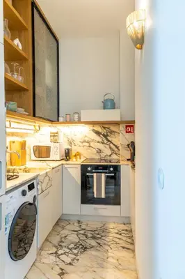 a kitchen with a washer and dryer at Casa Flores - in Historical Center in Porto