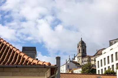 a view of a city with a clock tower at Casa Flores - in Historical Center in Porto