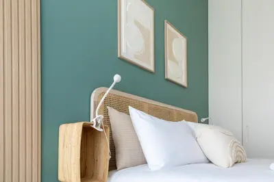 a bedroom with blue walls and a bed with white pillows at Casa Flores - in Historical Center in Porto