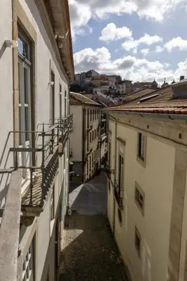 an alley way between buildings in a city at Casa Flores - in Historical Center in Porto