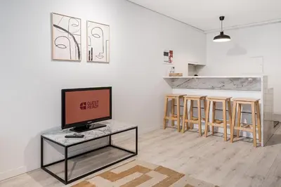 a living room with a tv and a table at GuestReady - Homely stay in Porto in Porto