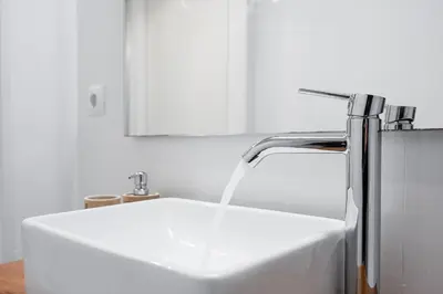 a kitchen sink with water coming out of a faucet at GuestReady - Homely stay in Porto in Porto