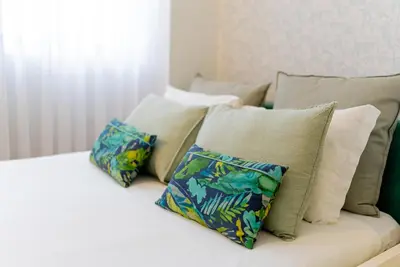 a white couch with pillows on top of it at Cosy Charm Bonfim in Porto