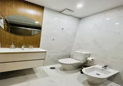 a bathroom with a toilet and a sink and a mirror at Trindade 99 - Porto Downtown Apartment in Porto