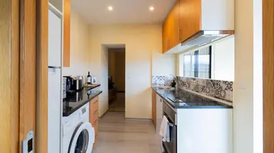a kitchen with a washer and dryer in it at 2BR Home near Douro River by LovelyStay in Vila Nova de Gaia