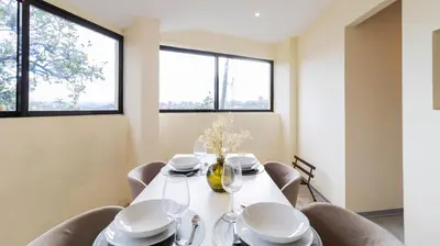 a dining room with a white table and chairs at 2BR Home near Douro River by LovelyStay in Vila Nova de Gaia