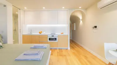 a kitchen with a bed and a sink in a room at 3T Charming apartment in Boavista in Porto