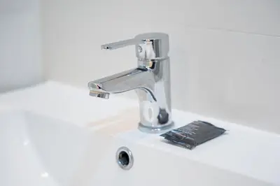 a kitchen sink with a faucet on a counter at GuestReady - Easygoing Pool to River in Vila Nova de Gaia