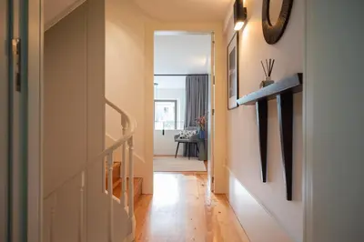 a hallway with a stairway leading to a room at Classy Garden in Porto