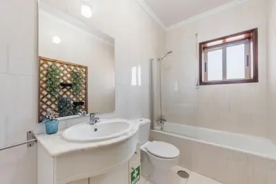 a bathroom with a sink and a toilet and a tub at GuestReady - Porto Panoramic View in Vila Nova de Gaia