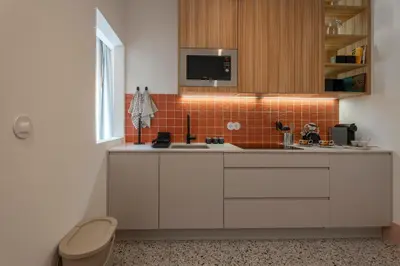 a kitchen with white cabinets and a sink at Casa Priorado - Charming View City Center in Porto