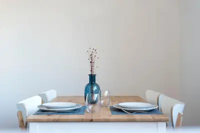 a wooden table with plates and a vase on it at Apartment Boavista Roundabout by Sweet Porto in Porto
