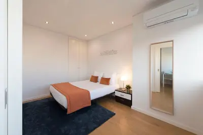 a bedroom with a bed and a mirror at Apartment Boavista Roundabout by Sweet Porto in Porto