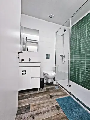 a bathroom with a toilet and a glass shower at Ninho Studio in Vila Nova de Gaia