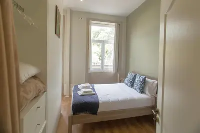a small bedroom with a bed and a window at Cedofeita Downtown Nightlife by PCH in Porto