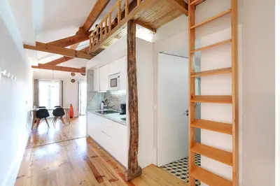 a room with a staircase leading to a kitchen with white cabinets at VIVA Boho Chic in Porto