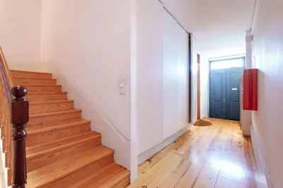 an empty hallway with stairs and a blue door at VIVA Boho Chic in Porto