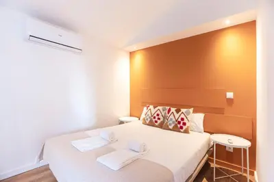 a bedroom with a bed with two towels on it at FLH Porto Central TownHouse in Porto