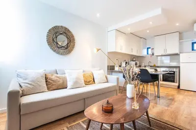 a living room with a couch and a table at FLH Porto Central TownHouse in Porto