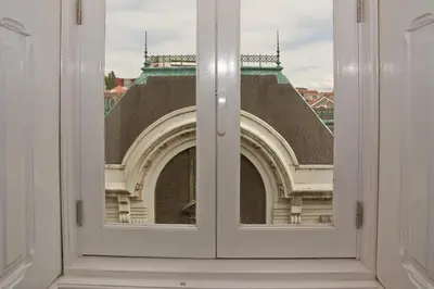 a view of a building through a window at Bolhão Nobre Apartments in Porto