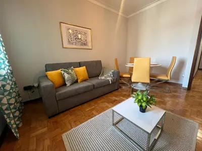 a living room with a couch and a table at Happy Mountain in Porto