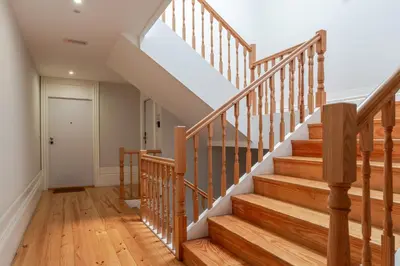 a staircase in a home with wood floors at Topazio Apartment by Porto Stories in Porto
