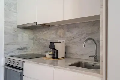a kitchen counter with a sink and a mixer at Topazio Apartment by Porto Stories in Porto