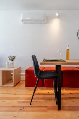 a table and a chair in a room with a bed at Topazio Apartment by Porto Stories in Porto