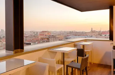 a man and a woman sitting at a table at Hotel Premium Porto Downtown in Porto