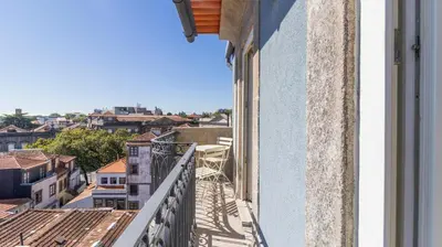 a balcony with a view of a city at Carmo Apartamentos in Porto