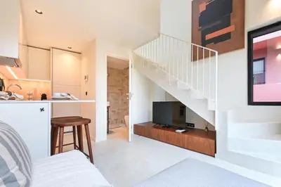 a room with a staircase and a living room at ON Apartments - Cozy - Free Parking & Pet Friendly in Porto