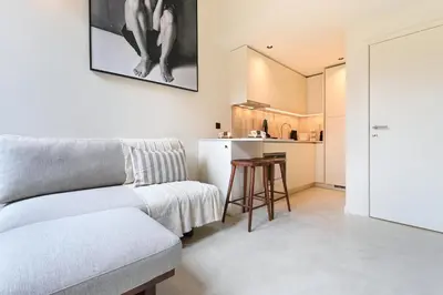 a living room with a couch and a kitchen at ON Apartments - Cozy - Free Parking & Pet Friendly in Porto