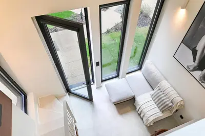 a room with large windows and white furniture at ON Apartments - Cozy - Free Parking & Pet Friendly in Porto