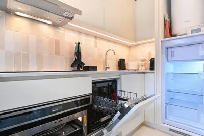 a kitchen with a wine rack in a refrigerator at ON Apartments - Cozy - Free Parking & Pet Friendly in Porto